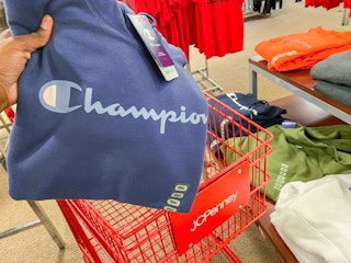 hand holding champion hoodie