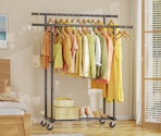 a rolling rack with clothes on it in a room