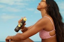 a woman spraying sun bum sunscreen