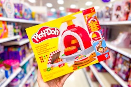 hand holding a play-doh pizza oven playset in a target aisle