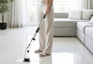 a person cleaning floors with a spin scrubber