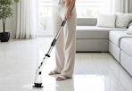 a person cleaning floors with a spin scrubber