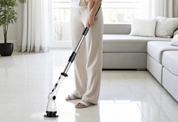 a person cleaning floors with a spin scrubber
