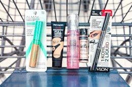 concealer, foundation, face mist, highlighter, and eyeliner in a cart