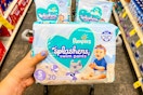 hand holding pampers splashers swim pants diapers