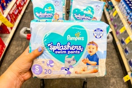 hand holding pampers splashers swim pants diapers