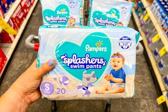 hand holding pampers splashers swim pants diapers