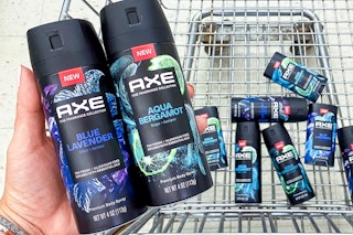 person holding axe fine fragrance collection near walgreens shopping cart