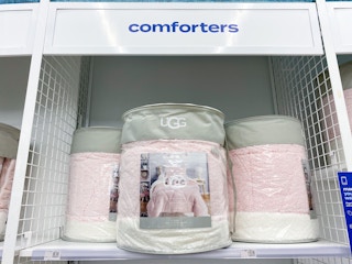 a display of ugg comforters on a shelf in bed bath and beyond