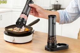 salt being poured on food in skillet