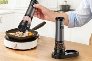 salt being poured on food in skillet