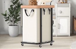 a laundry basket on wheels in a room