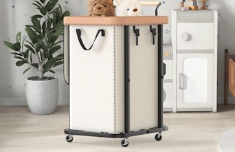 a laundry basket on wheels in a room
