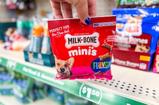 hand holding a bag of milk-bone dog treats