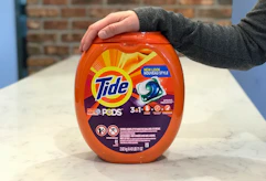 Tide pods with arm resting on top