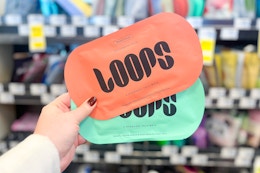 hand holding two loops face masks