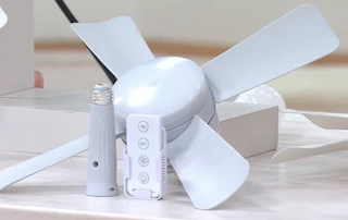 a socket fan in a room over flowers