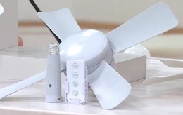 a socket fan in a room over flowers
