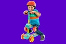 Toddler using the fold down seat on the CoComelon scooter