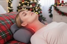 a woman laying on a cervical neck pillow