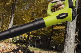 a woman using a long leaf blower