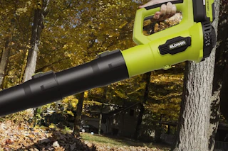 a woman using a long leaf blower