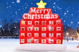 PETUOL Christmas Advent Calendar Inflatable outside in the snow at night.