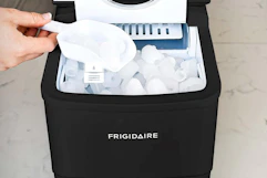 a woman using a bullet ice maker