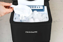 a woman using a bullet ice maker