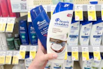 hand holding up two head and shoulders shampoos