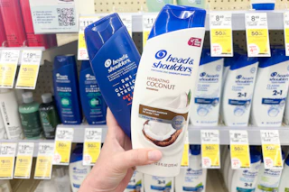 hand holding up two head and shoulders shampoos
