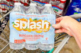 hand touching a pack of splash water in cart