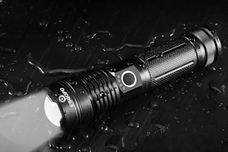 Flashlight laying on table.