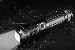 Flashlight laying on table.