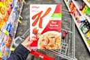 person holding a box of special k cereal over a cvs cart