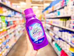 OxiClean Odor Blaster held up in center aisle at Walmart