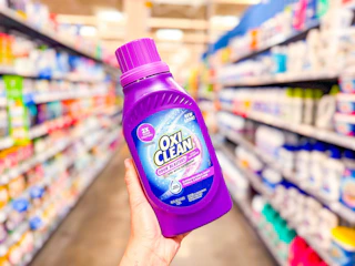 OxiClean Odor Blaster held up in center aisle at Walmart