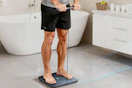 man standing on smart scale