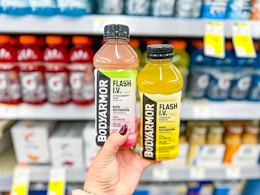 hand holding two bottles of body armor flash