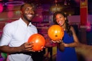 two people bowling and smiling