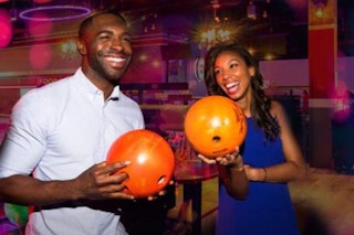 two people bowling and smiling