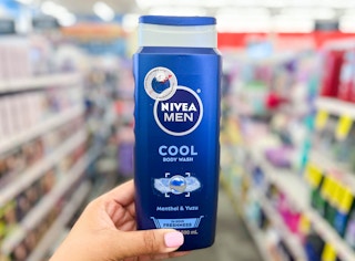 hand holding bottle of Nivea Men body wash