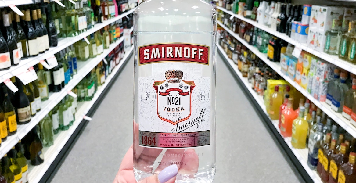 hand holding smirnoff no 21 bottle in store aisle