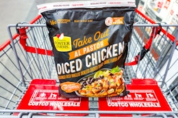 hand holding a bag of costco foster farms take out al pastor chicken