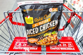 hand holding a bag of costco foster farms take out al pastor chicken