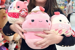 someone holding up some valentine's day squishmallows at walgreens