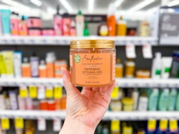 person holding sheamoisture styling gel