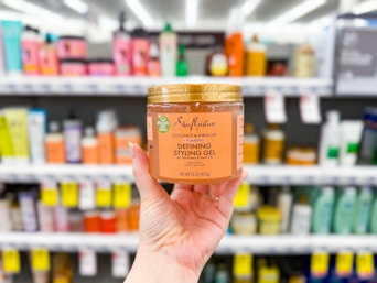 person holding sheamoisture styling gel