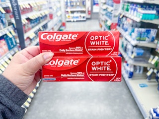 hand holding colgate toothpaste in walgreens