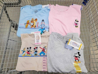 Some Disney shirts in a cart at Sam's Club